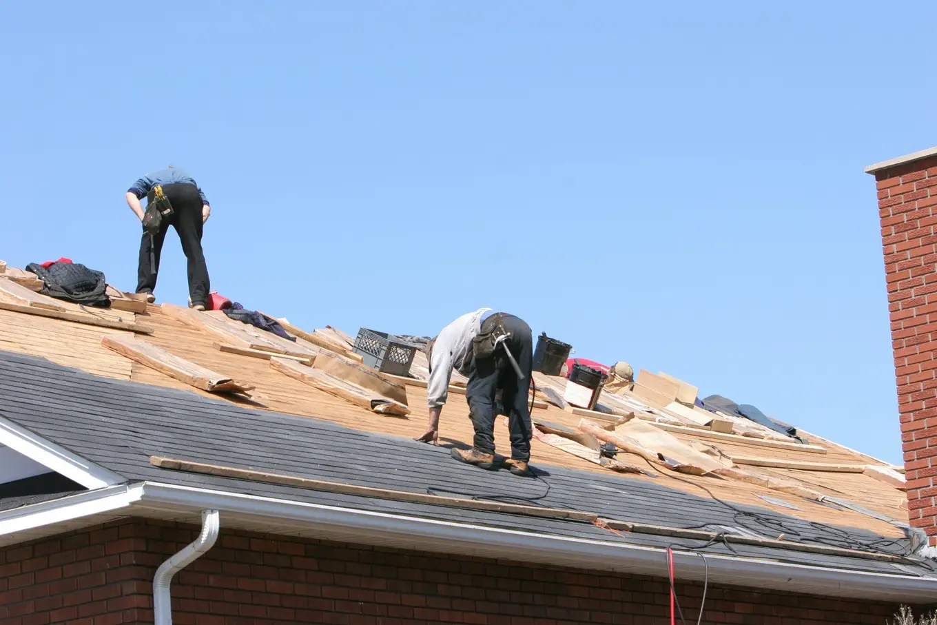 dwóch pracowników podczas remontu dachu